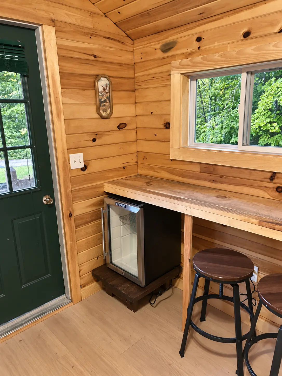 Counter and stools beside a window and entry door